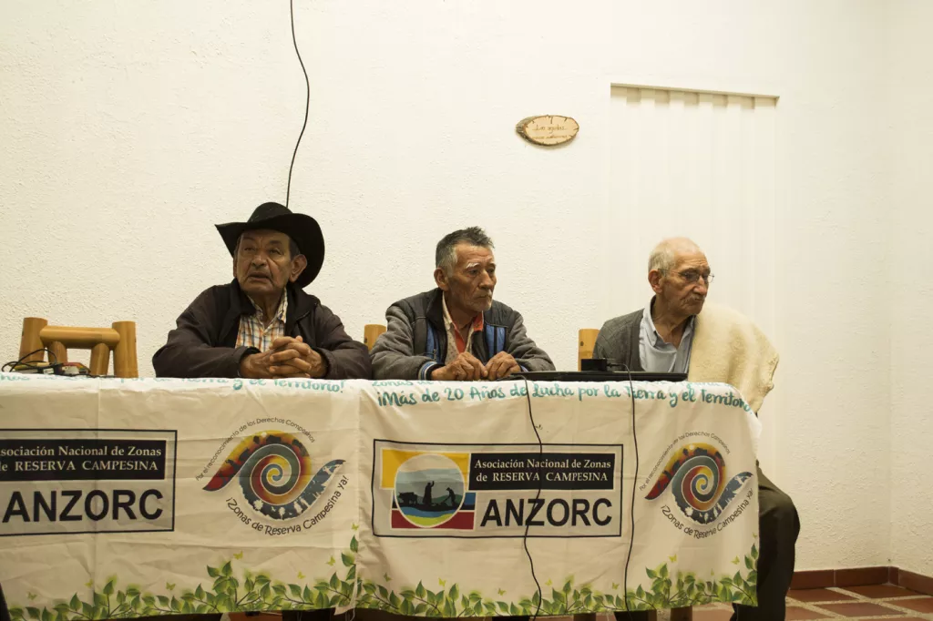 Three men from ANZORC holding a press conference