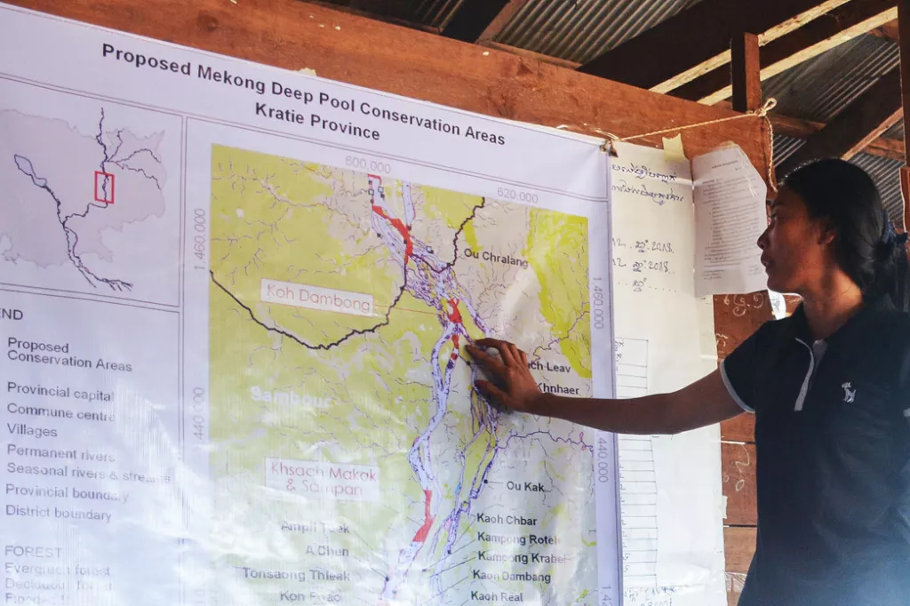 Song Rany showing on a map of the mekong river where they have preserved the nature.