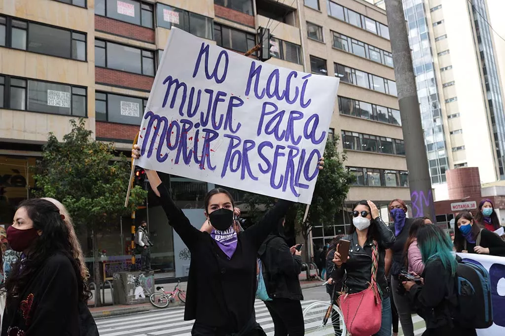 Woman holding protest sign during women's rights protest in Bogotà Colombia