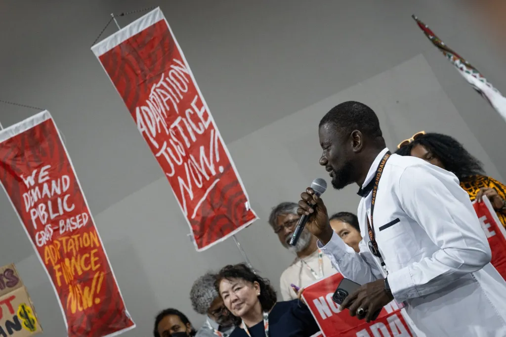 Man protesting during COP30 for adaptation justice