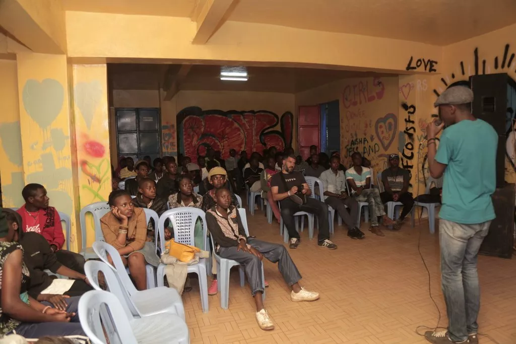 A spoken word artist performs his piece during an open forum by Creative Spills in Kibera, Nairobi