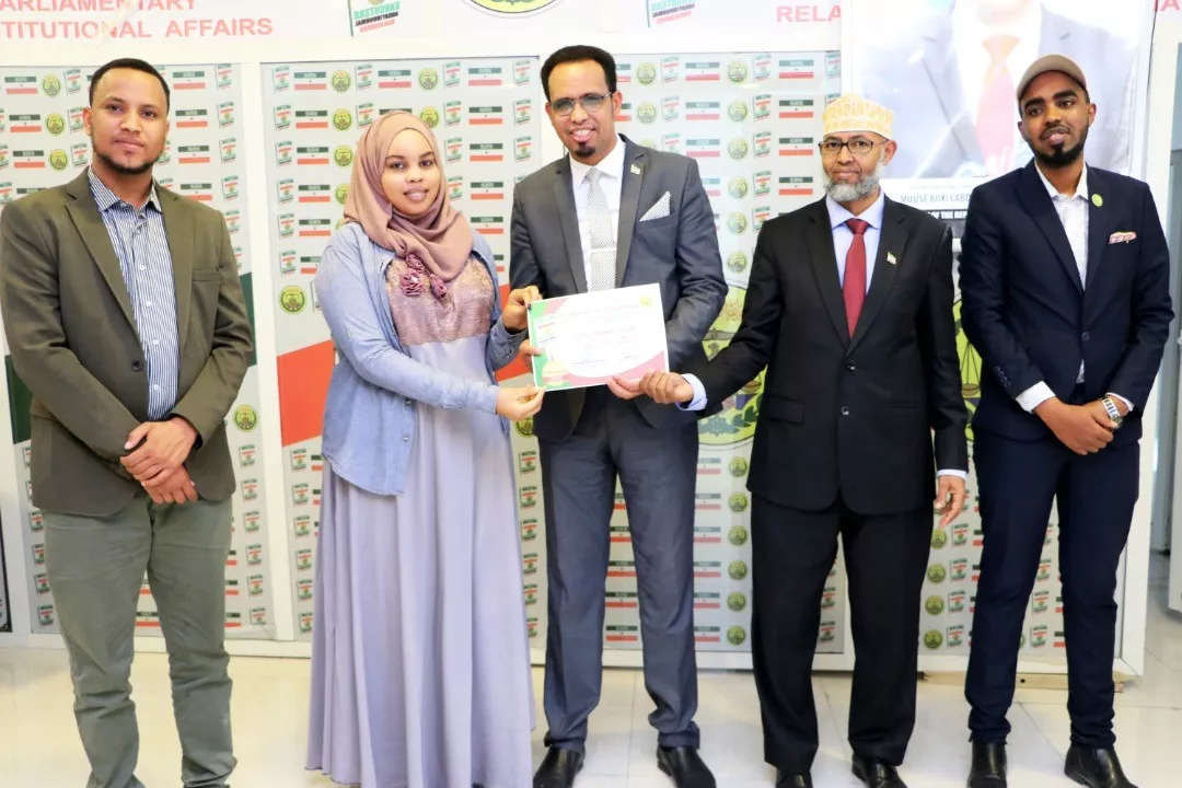 Asma Saeed receives a certification of recognition for her work from the minister of parliamentary relations and constitutional affairs in Hargeisa, Somaliland.