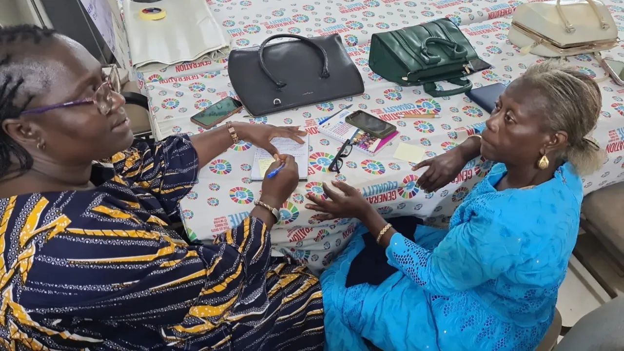 Two women taking notes in a workshop