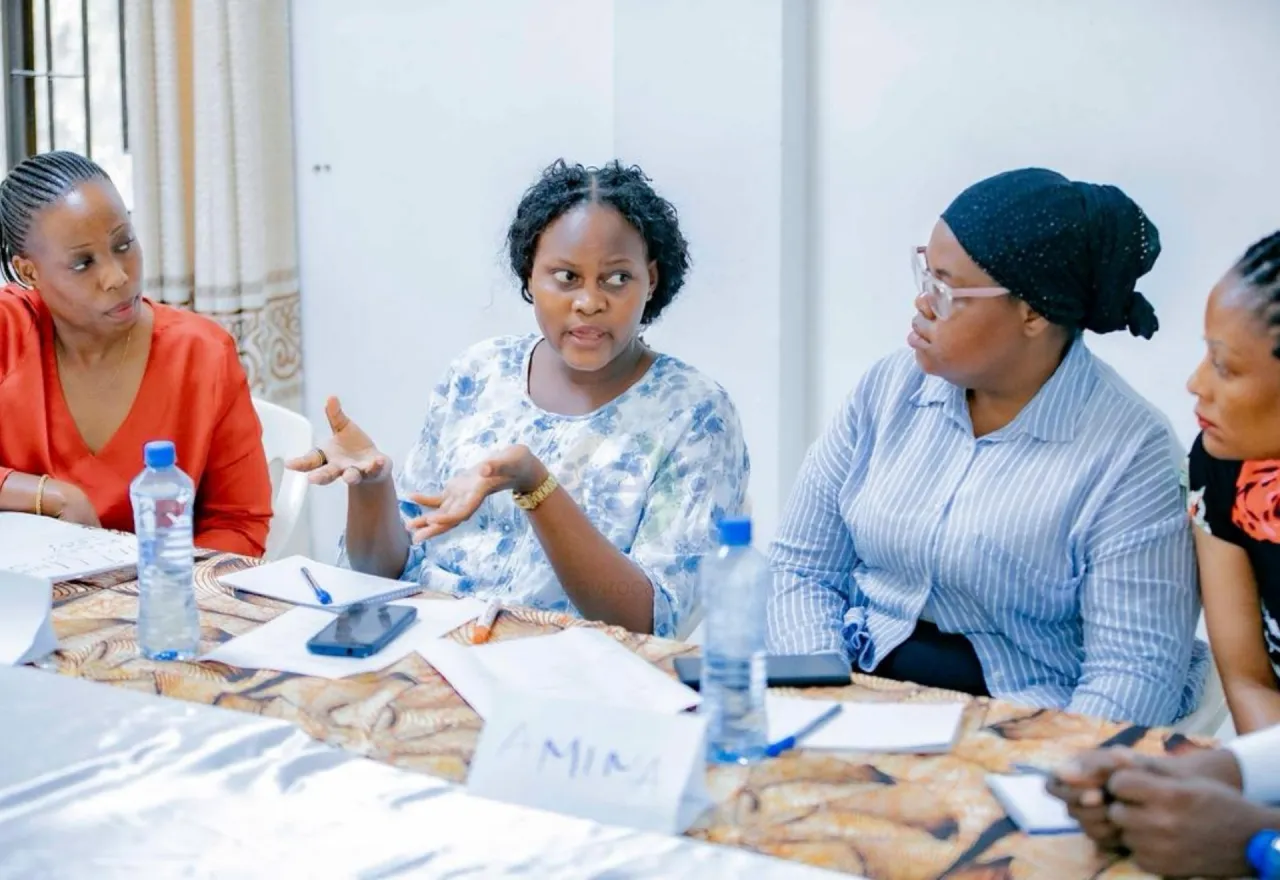 Four women discussing at a table