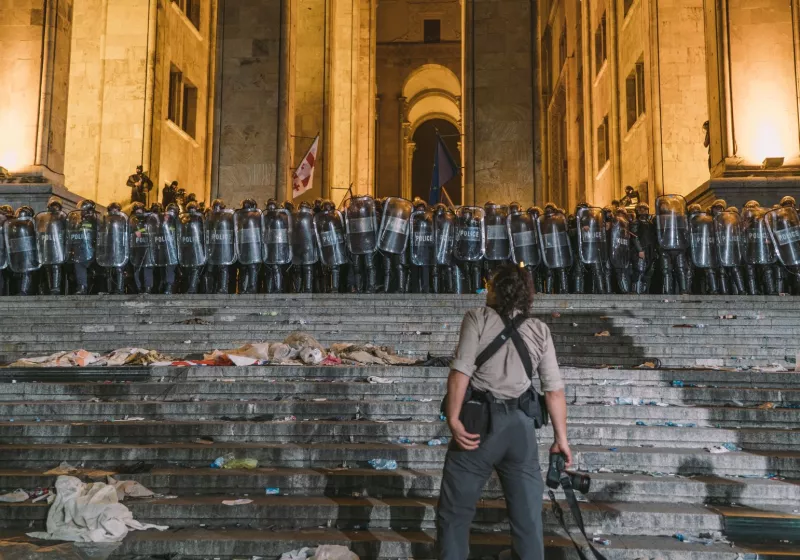 A person standing in front of riot police during protests in Tbilisi in 2019. Photo by Tbel Abuseridze.