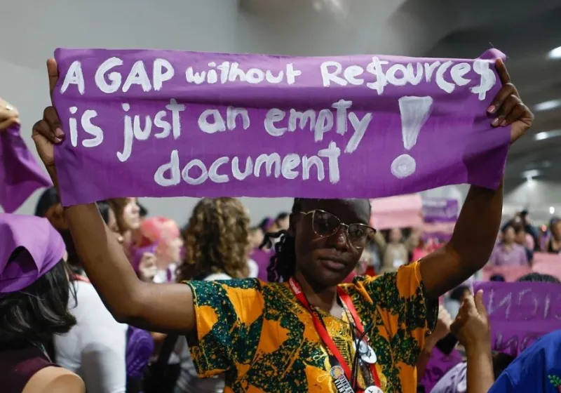 Women at COP30 holding banner with the text A gap without resources is just an empty document.