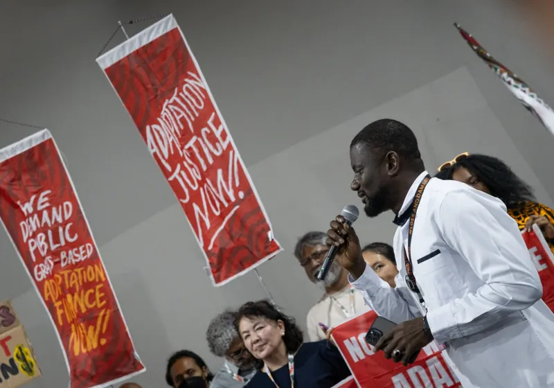 Man protesting during COP30 for adaptation justice