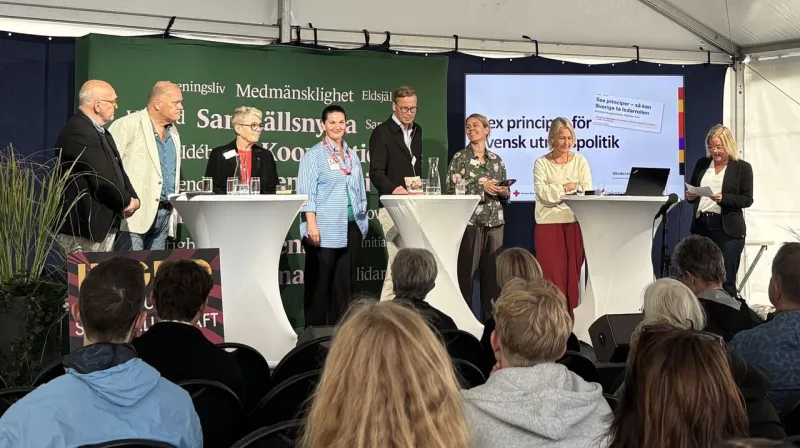 Undertecknarna för artikeln står på en scen och pratar under Frihamnsdagarna i Göteborg.